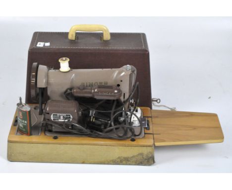 A vintage Singer sewing machine, serial number K9961841, in original carry case with a selection of accessories.