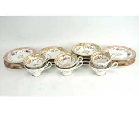 A Victorian part tea service, comprising cups, saucers and small plates, all decorated with flowers and gilt foliage on a whi