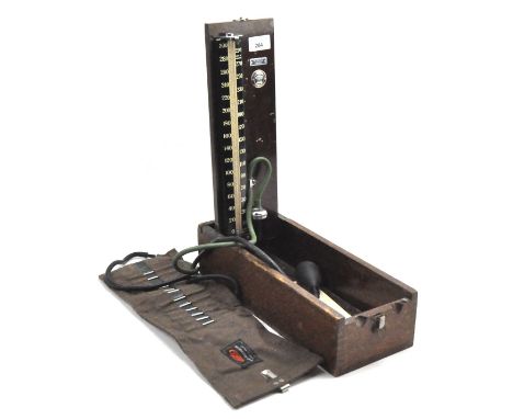 A vintage blood pressure monitor, model no.76755, fitted into a hinged wooden box with the original instructions, height (ope