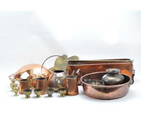 A collection of brass and copper, 19th century and later, including a copper planter, a two-handled copper pan, a pierced bra