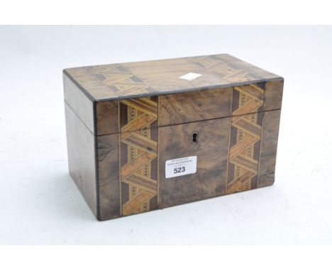A Victorian walnut veneer Tunbridge ware tea caddy with two bands of zig-zag ribboning across the lid and running down the fr