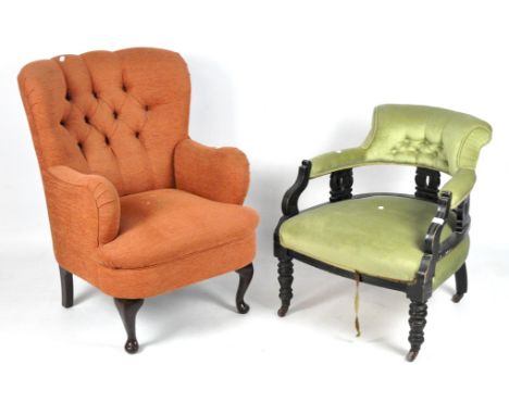 A Victorian armchair and a contemporary armchair, the earlier with green upholsterery on castors, the other in orange, both w