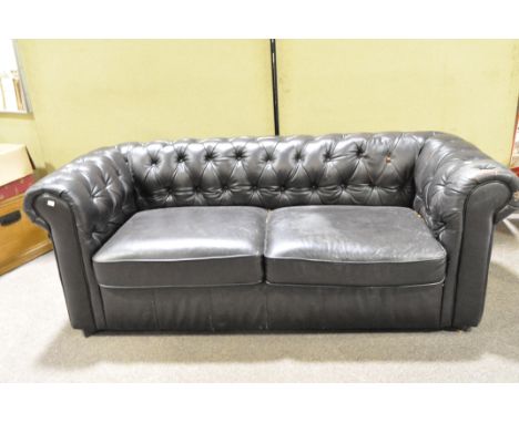 A two seater chesterfield sofa, upholstered in dark brown leatherette, with button back and sides, 72.5 cm high x 191 cm wide