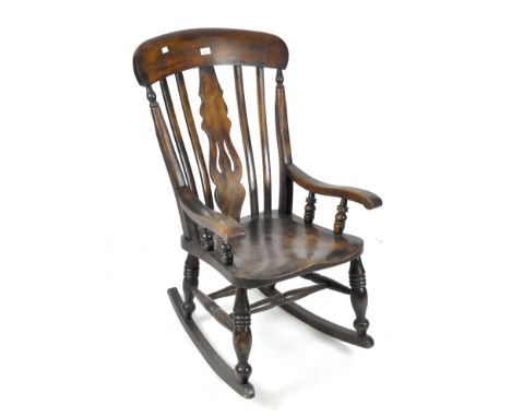 A Victorian fiddle back rocking chair and a footstall, the first with shaped seat and turned supports, height 101cm, the seco