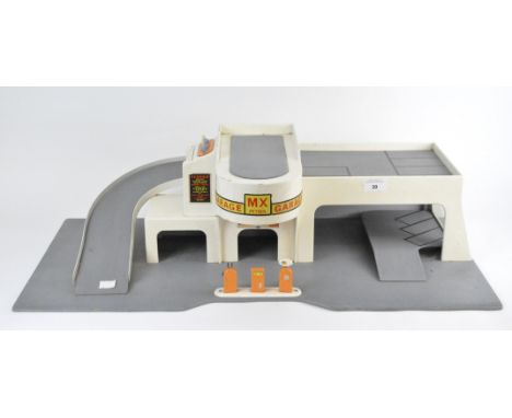 A vintage toy garage, the wooden structure marked 'MX Petrol', painted in cream with decorative stickers and featuring three 