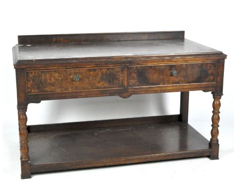 An early 20th century mahogany low sideboard, the rectangular top above two short drawers and a storage shelf, measuring 64cm