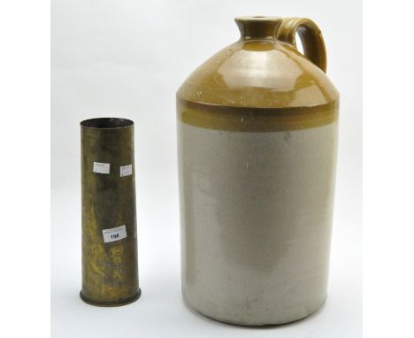 A brass ammunition shell case and a large stoneware flagon, the first of cylindrical form, 29.3cm high, the flagon part glaze