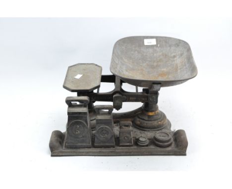 A set of cast metal kitchen scales and weights, all mounted in a fitted stand with removeable tray, height 25cm