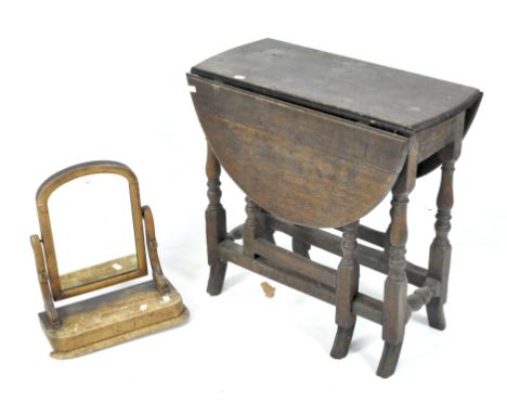 An oak gate leg table &amp; Victorian dressing table mirror, the table on turned baluster legs, on splayed feet, 69 cm high x
