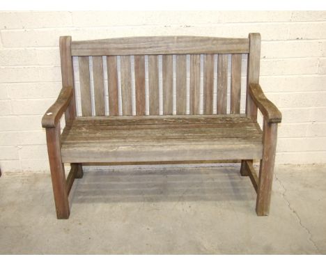 A teak garden bench, 123cm wide.