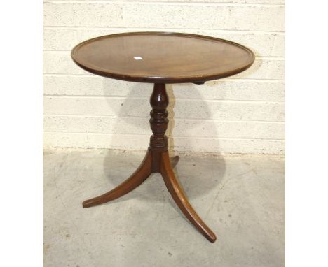 A Georgian mahogany circular tilt-top tripod table, on turned column and plain swept legs, 58cm diameter, (legs repaired) and