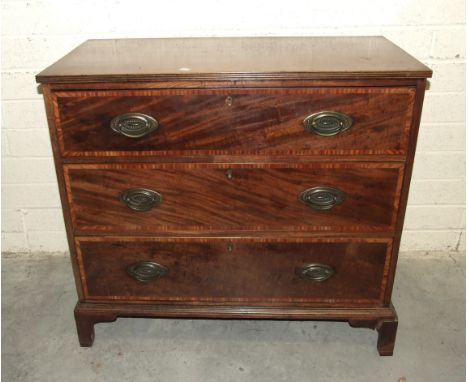A Georgian mahogany chest of three long cross-banded drawers, on bracket feet, 98cm wide, 89cm high.