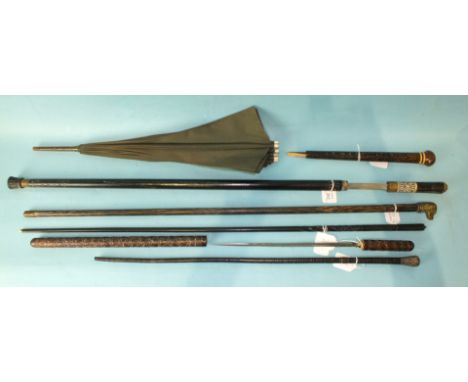 A white-metal-mounted leather swagger stick, a carved wood swagger stick/stiletto and other items. 