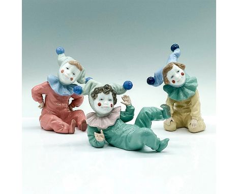 Three porcelain figures of children jester. Jingles in red, Jangles in green, and Joy in yellow. Nao backstamps. Jingles: 106