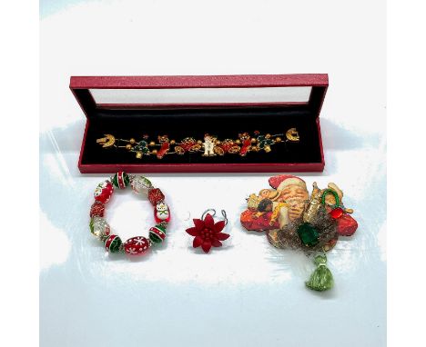Pin: Santa Clause holding toys. 3.75"L x 3.75"W. Ring: Adjustable size, red poinsettia flower with leather petals and wood be