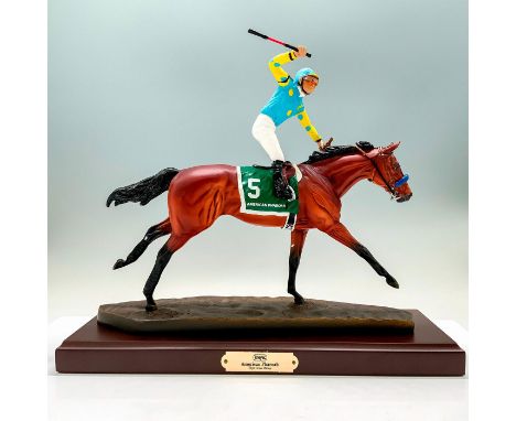 This figure depicts the horse American Pharaoh and his jockey during a horse race. The base is a dark brown rectangle. Dimens