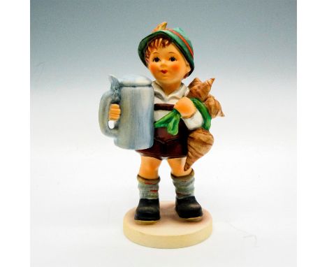 Collectible porcelain figurine of a boy holding turnips and a blue beer stein. Hand painted figure with matte finish. Goebel 