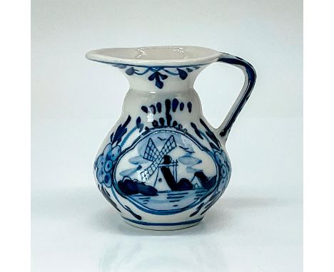 Cream or syrup pitcher fired in the Delft or faience style, resulting in the traditional blue and white decorations. Dimensio