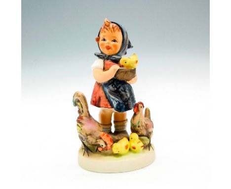 A collectable porcelain hand painted figurine of a young girl feeding farm animals. Matte finish figure on round base. Goebel