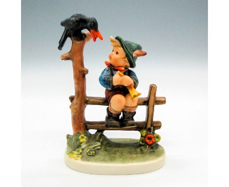 Porcelain figurine of a boy seated on a fence looking at a bird. Hand painted matte finished item. Goebel backstamp. Artist: 