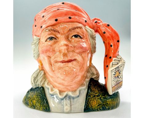 This mug depicts a fortune teller dressed in a red head scarf and jacket and button up. Tarot cards and the knot of the heads