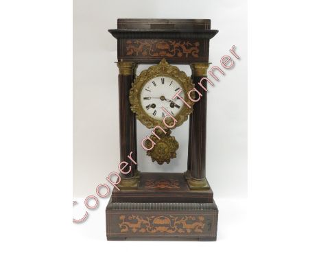 A 19th century French 'Portico' style 8 day mantle clock, enamel dial with decorative bezel and pendulum, bell strike but no 