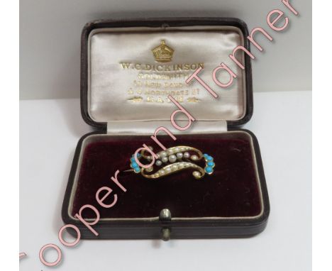 An Edwardian seed pearl and turquoise brooch, stamped '15ct', of double scroll form, 3.2 cm long, 4.3 g gross, cased