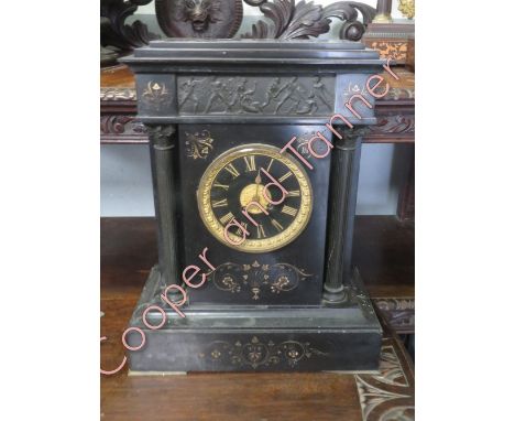 A large French 8 day black slate mantel clock, striking on a gong with pendulum but no key. 