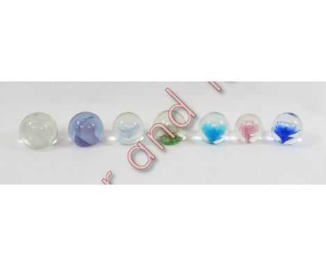 Twelve assorted glass paperweights including examples by Caithness and a limited edition Selkirk Typhoon 356/500