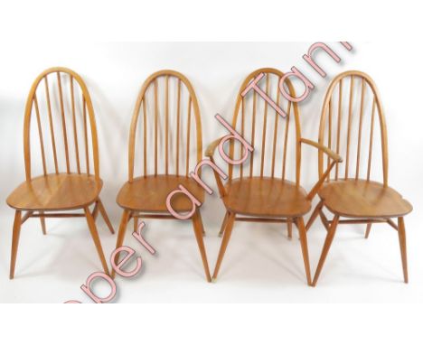 A set of four (three standard on carver) Ercol light wood stick back chairs