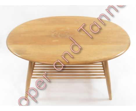 An Ercol lightwood oval coffee table 43cms high