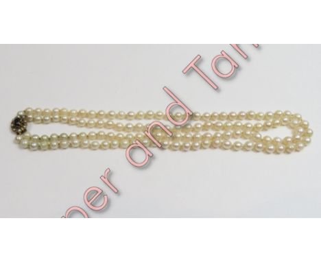 A uniform two row cultured pearl necklace, the 63 and 59 pearls of approximately 6.5/7.4 mm diameter, to a 9 carat gold smoky