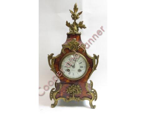 A French boulle style 8 day mantel clock striking on gong, the case with tortoiseshell style effect with brass fittings, with