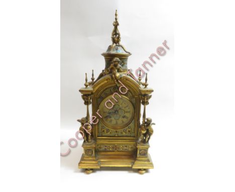 A French late 19th century brass inlaid enamel mantel clock, with brass cherubs above the arch and side columns. Brass dial s