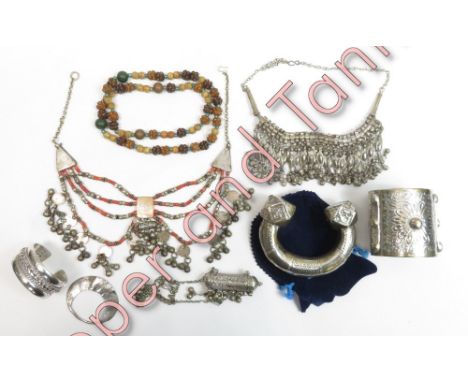 A small collection of Bedouin jewellery, including an Egyptian bangle, beads and other items in white metal