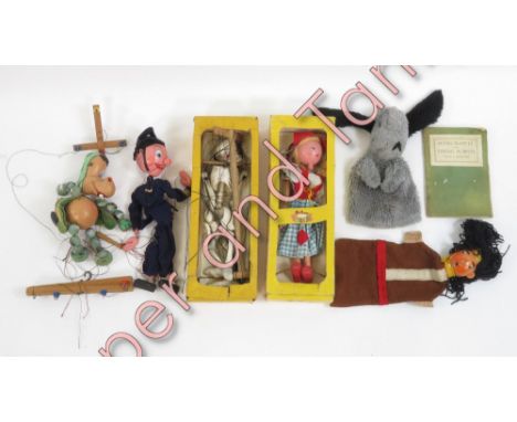 A Pelham Dutch Girl puppet in original box with label; a skeleton puppet in box for Gepetto; an unboxed Pelham policeman and 