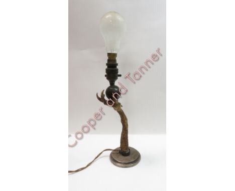 A taxidermy turkey leg, formed in a lamp standing on silver base, London 1907, 34cm high