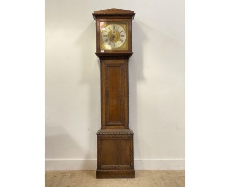 An Irish longcase clock, 18th century and later, the carved oak case with panelled trunk door and base enclosing a gilt brass