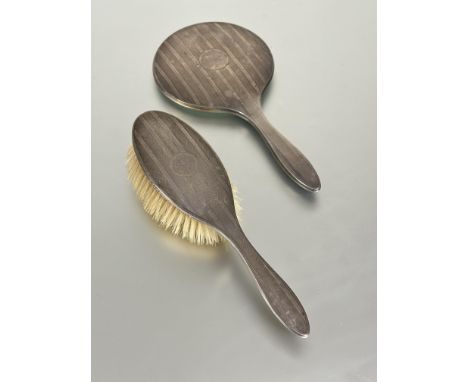 A Birmingham silver two piece dressing table set to include and hand mirror L x 27cm&nbsp; and hair brush with original natur