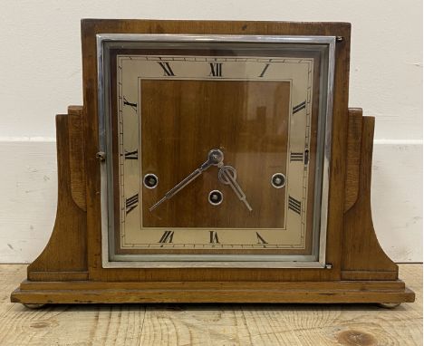 A large German Art Deco style mantel clock, with a stepped mahogany case enclosing a silvered dial with Roman chapter ring, p