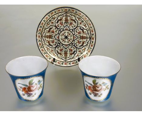 A pair of Continental porcelain cache pots in the Sevres style with oval floral sprays in gilt borders on turquoise blue rese