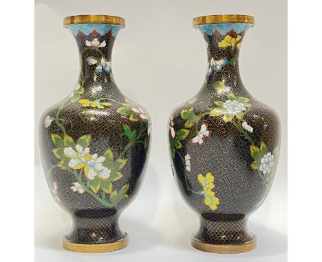 A pair of Republic period Chinese cloisonne enamel vases decorated with floral sprays and butterflies against a black manji p
