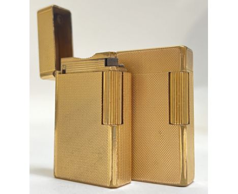 A pair of gold plated Dupont cigarette roller lighters with crosshatch engraved design (marks to base, h- 6cm)