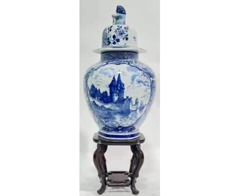 A Dutch Delft blue and white Chinese style ceramic jar decorated with typical European panels scenes with lion knop (marked v