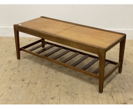Remploy, a 1960s metamorphic teak coffee table, top opening to centre inset with tiles above a slatted magazine shelf. H41cm,