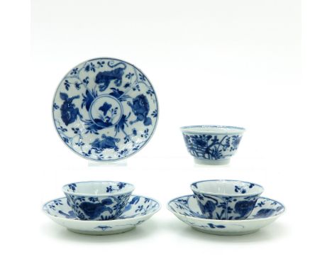 Blue and white decor depicting temple lions and tigers, marked with double ring and Chinese symbol, saucers are 11 cm. in dia
