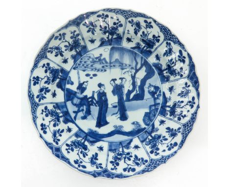 Depicting gathering of Chinese figures in garden, floral decor border, 27 cm. in diameter, light fritting on edge.