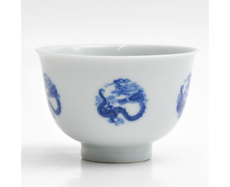 Decorated with five dragons on outside of cup with one dragon in center, Kangxi mark, 9 cm. in diameter.