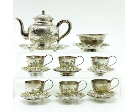 Including teapot, cups and saucers, two small trays and round serving dish, teapot is 10 cm. tall.