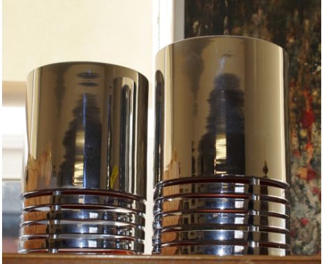 A pair of Retro modern chrome tubular light shades with orange coloured interior